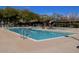 Community pool with deck chairs and mature trees offering a refreshing retreat on a sunny day at 2425 W Bronco Butte Trl # 2028, Phoenix, AZ 85085