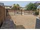 This spacious gravel backyard includes a fence with a pool behind and an air conditioning unit at 2514 W Big Oak St, Phoenix, AZ 85085