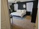 The soothing bedroom features black accent walls, a ceiling fan, and soft natural lighting at 2514 W Big Oak St, Phoenix, AZ 85085