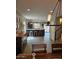 Open living room showing wood floors, eat-in kitchen and modern light fixtures at 2514 W Big Oak St, Phoenix, AZ 85085