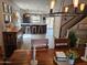 Open living room showcasing wood floors, modern light fixtures and an eat-in kitchen at 2514 W Big Oak St, Phoenix, AZ 85085