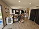 Spacious living area with wood-look floors, a view into another room, and two pet kennels in the shot at 2514 W Big Oak St, Phoenix, AZ 85085