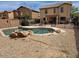 This backyard features a private pool surrounded by rocks, gravel, and an iron fence at 2514 W Big Oak St, Phoenix, AZ 85085
