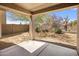 Covered patio overlooks the backyard with desert landscaping and mountain views at 2610 W Sat Nam Way, Phoenix, AZ 85086