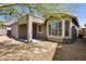 Backyard with covered patio, stone pavers, and desert landscaping at 2610 W Sat Nam Way, Phoenix, AZ 85086