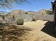 Gravel backyard featuring desert landscaping, block wall and fence with views of the mountains beyond at 2610 W Sat Nam Way, Phoenix, AZ 85086