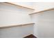 Walk-in closet with wood bar and shelving for storage at 2610 W Sat Nam Way, Phoenix, AZ 85086