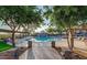 Beautiful community pool featuring lounge chairs and shaded seating areas at 2610 W Sat Nam Way, Phoenix, AZ 85086