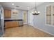 Spacious kitchen area with stainless steel appliances, wood cabinets, tile floors, and bright light at 2610 W Sat Nam Way, Phoenix, AZ 85086