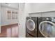 Laundry room equipped with washer and dryer, plus shuttered window at 2610 W Sat Nam Way, Phoenix, AZ 85086