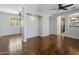 Open living room showcasing hardwood floors, fresh paint and open access to other areas in the home at 2610 W Sat Nam Way, Phoenix, AZ 85086