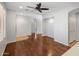 Spacious living room featuring hardwood floors, a ceiling fan, and access to multiple areas of the home at 2610 W Sat Nam Way, Phoenix, AZ 85086
