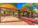 Community picnic area featuring shaded ramadas and red picnic tables at 2610 W Sat Nam Way, Phoenix, AZ 85086
