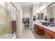 Bright bathroom featuring a glass-enclosed shower, double sinks, and ample storage at 269 W Seaside Dr, Casa Grande, AZ 85122