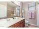 Bright bathroom featuring double sinks, a large mirror, and a shower-tub combination at 269 W Seaside Dr, Casa Grande, AZ 85122