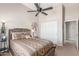Comfortable bedroom with a ceiling fan, closet, and decorative tree art hanging on the wall at 269 W Seaside Dr, Casa Grande, AZ 85122
