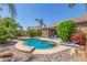 A backyard pool surrounded by lush foliage and desert landscaping provides a private escape at 269 W Seaside Dr, Casa Grande, AZ 85122