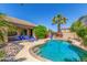 Backyard pool with rock features, lounge chairs, and desert landscaping offers a serene retreat at 269 W Seaside Dr, Casa Grande, AZ 85122