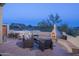 Backyard showing an inviting outdoor setup with a hot tub, fireplace, and comfortable lounge area at 28437 N 112Th Way, Scottsdale, AZ 85262