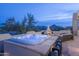 Inviting outdoor space with a hot tub and fireplace; ideal for relaxation with desert scenery at 28437 N 112Th Way, Scottsdale, AZ 85262