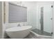 Bright bathroom featuring a soaking tub and a walk-in shower with glass door and modern fixtures at 28437 N 112Th Way, Scottsdale, AZ 85262