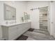Bright bathroom featuring a double vanity with modern fixtures, and a barn door to a walk-in closet at 28437 N 112Th Way, Scottsdale, AZ 85262