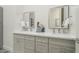 Bathroom featuring a double vanity with modern fixtures, white countertops, and decorative accents at 28437 N 112Th Way, Scottsdale, AZ 85262