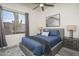 Stylish bedroom featuring modern furnishings, ceiling fan, artwork, and a window with desert views at 28437 N 112Th Way, Scottsdale, AZ 85262