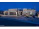 Elegant home exterior at twilight, highlighting the desert landscaping, gray doors, and lighting accents at 28437 N 112Th Way, Scottsdale, AZ 85262