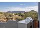 Outdoor kitchen featuring a modern grill and countertop, with picturesque mountain views in the background at 28437 N 112Th Way, Scottsdale, AZ 85262