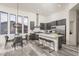 Modern kitchen with dark cabinets, stainless steel appliances, and a large island with bar seating at 28437 N 112Th Way, Scottsdale, AZ 85262