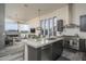 Gourmet kitchen with an island, top-of-the-line appliances, and an open view to the living area at 28437 N 112Th Way, Scottsdale, AZ 85262