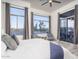 Bright main bedroom featuring large windows with views, stylish decor, and a sliding glass door at 28437 N 112Th Way, Scottsdale, AZ 85262