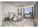 Bright main bedroom featuring a tufted headboard, ceiling fan, stylish decor, and lots of natural light at 28437 N 112Th Way, Scottsdale, AZ 85262
