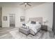 Bright main bedroom featuring a tufted headboard, ceiling fan, stylish decor, and luxury plank floors at 28437 N 112Th Way, Scottsdale, AZ 85262