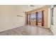 Bright bedroom with hardwood floors, neutral paint, modern ceiling fan, and multiple windows with curtains at 3131 E Legacy Dr # 2055, Phoenix, AZ 85042