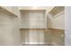 Walk-in closet with multiple shelves, rods, and neutral wall color, providing ample storage space at 3131 E Legacy Dr # 2055, Phoenix, AZ 85042