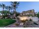 Well-maintained exterior featuring lush landscaping, palm trees, and the community's 'Cachet at the Legacy' sign at 3131 E Legacy Dr # 2055, Phoenix, AZ 85042