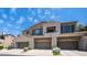 Welcoming townhome featuring beige paint, desert landscaping, and attached garages at 3131 E Legacy Dr # 2055, Phoenix, AZ 85042