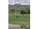 People play golf on the community golf course with mountain views and blue skies at 3131 E Legacy Dr # 2055, Phoenix, AZ 85042