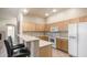 Bright kitchen features light wood cabinets, white appliances, and breakfast bar at 3131 E Legacy Dr # 2055, Phoenix, AZ 85042
