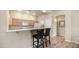 Kitchen with breakfast bar, wooden cabinets, and stainless steel appliances at 3131 E Legacy Dr # 2055, Phoenix, AZ 85042