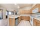 Stylish kitchen with light wood cabinets, white appliances, and eat-in bar at 3131 E Legacy Dr # 2055, Phoenix, AZ 85042