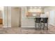 Open concept living room showcasing the kitchen, bar seating, and stair access at 3131 E Legacy Dr # 2055, Phoenix, AZ 85042