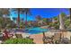 Community pool with lounge chairs, tables, chairs, and lush landscaping, perfect for relaxation and socializing at 3131 E Legacy Dr # 2055, Phoenix, AZ 85042