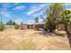 Large backyard with a large tree and an enclosed patio at 3136 W Voltaire Ave, Phoenix, AZ 85029
