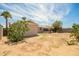Expansive backyard with desert landscaping and a covered patio, ideal for outdoor living at 3136 W Voltaire Ave, Phoenix, AZ 85029