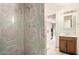 Bathroom featuring tiled shower and vanity at 3136 W Voltaire Ave, Phoenix, AZ 85029