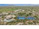 Aerial view of community with pools, tennis courts, clubhouse, and golf course amidst a beautiful desert landscape at 34457 N Legend Trail Pkwy # 1013, Scottsdale, AZ 85262