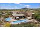 Stunning aerial view of a desert home with a large pool and patio area at 34457 N Legend Trail Pkwy # 1013, Scottsdale, AZ 85262